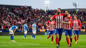 Atlético Madrid players celebrating a goal against Deportivo La Coruña in a LaLiga match.